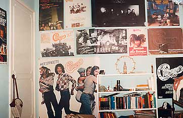Bedroom wall covered in posters